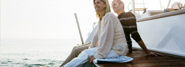 Reverse Mortgage for a New Home Purchase: Image of a happy middle aged couple on a boat.